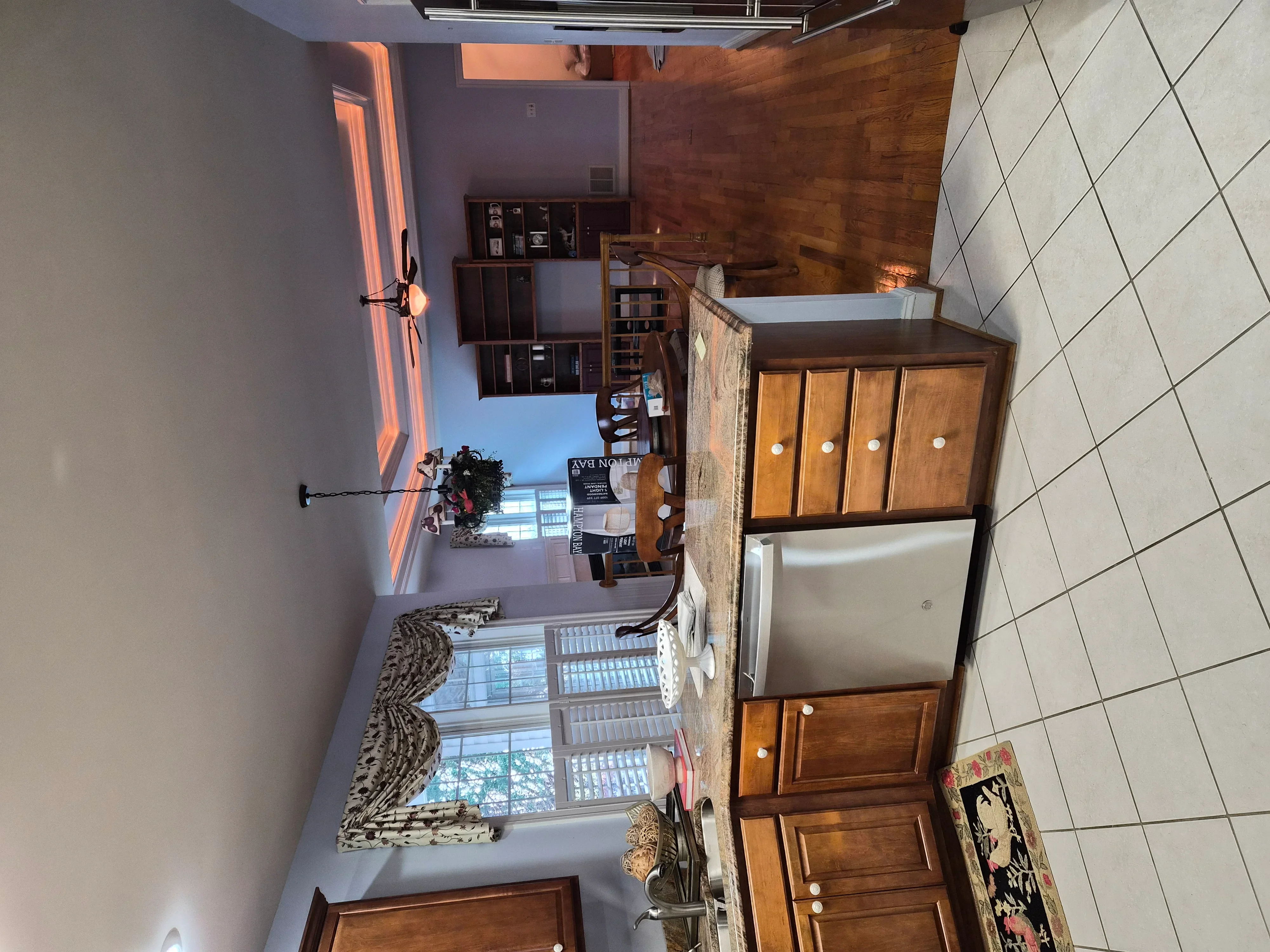 Interior room with white painted walls, neutral ceiling, and wood cabinetry