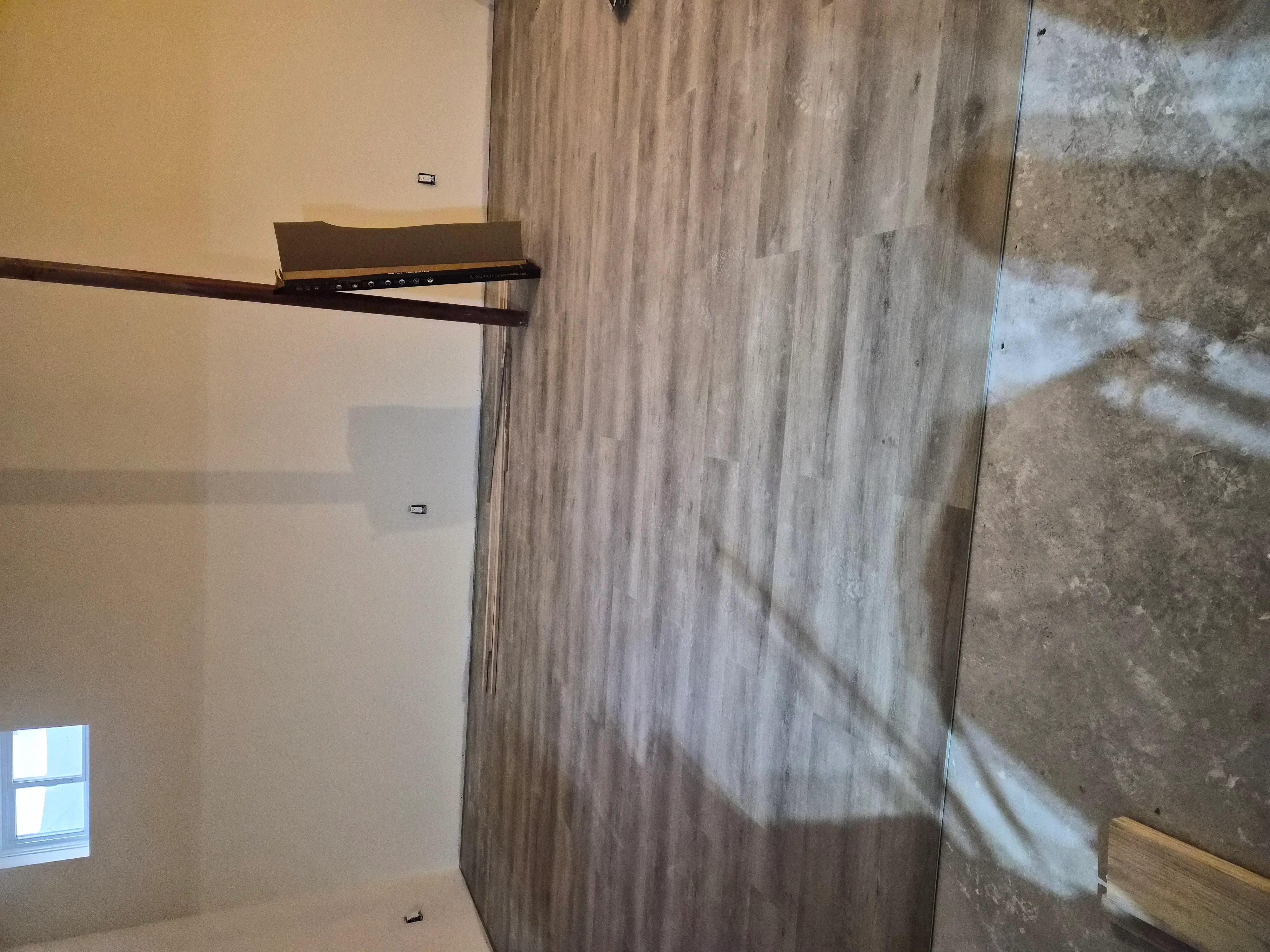 Drywall installation with finished walls and ceiling paint in residential interior space