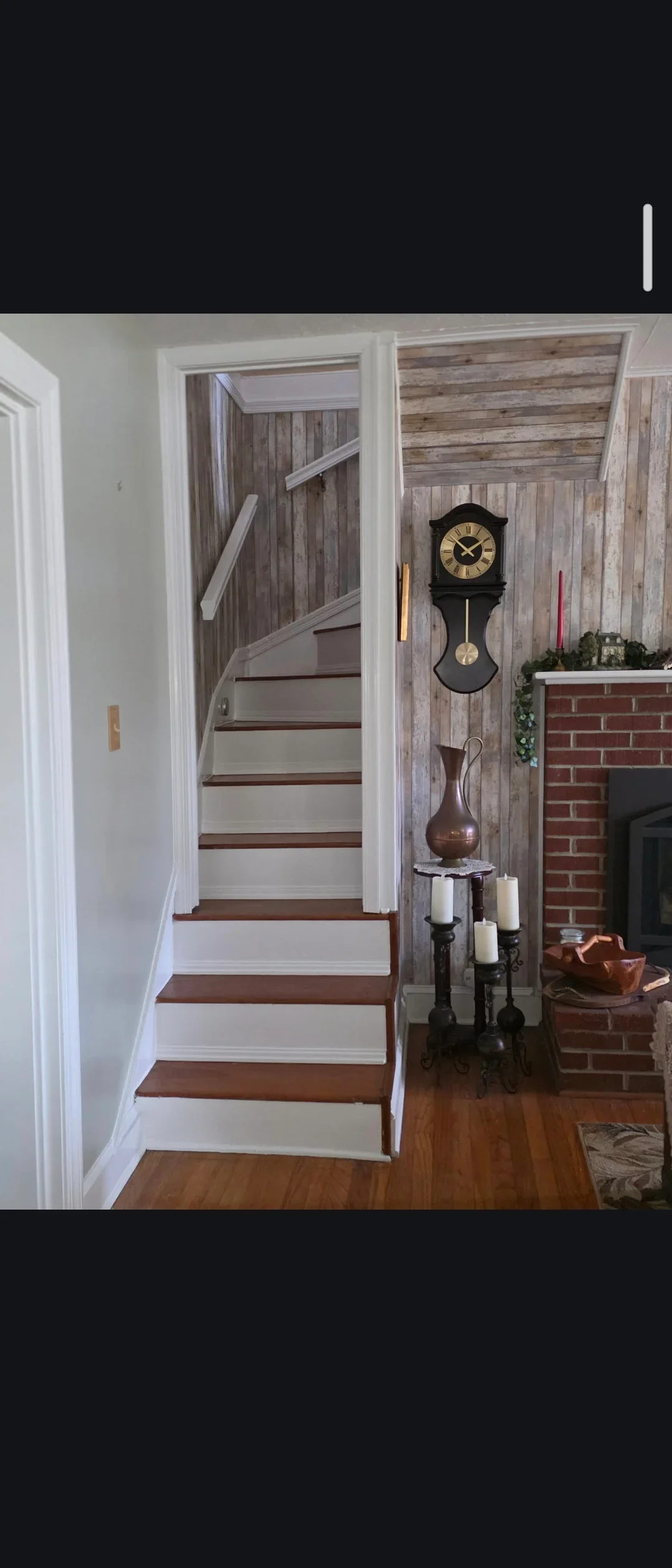 White painted staircase with dark wood treads, white trim, and painted walls in residential interior
