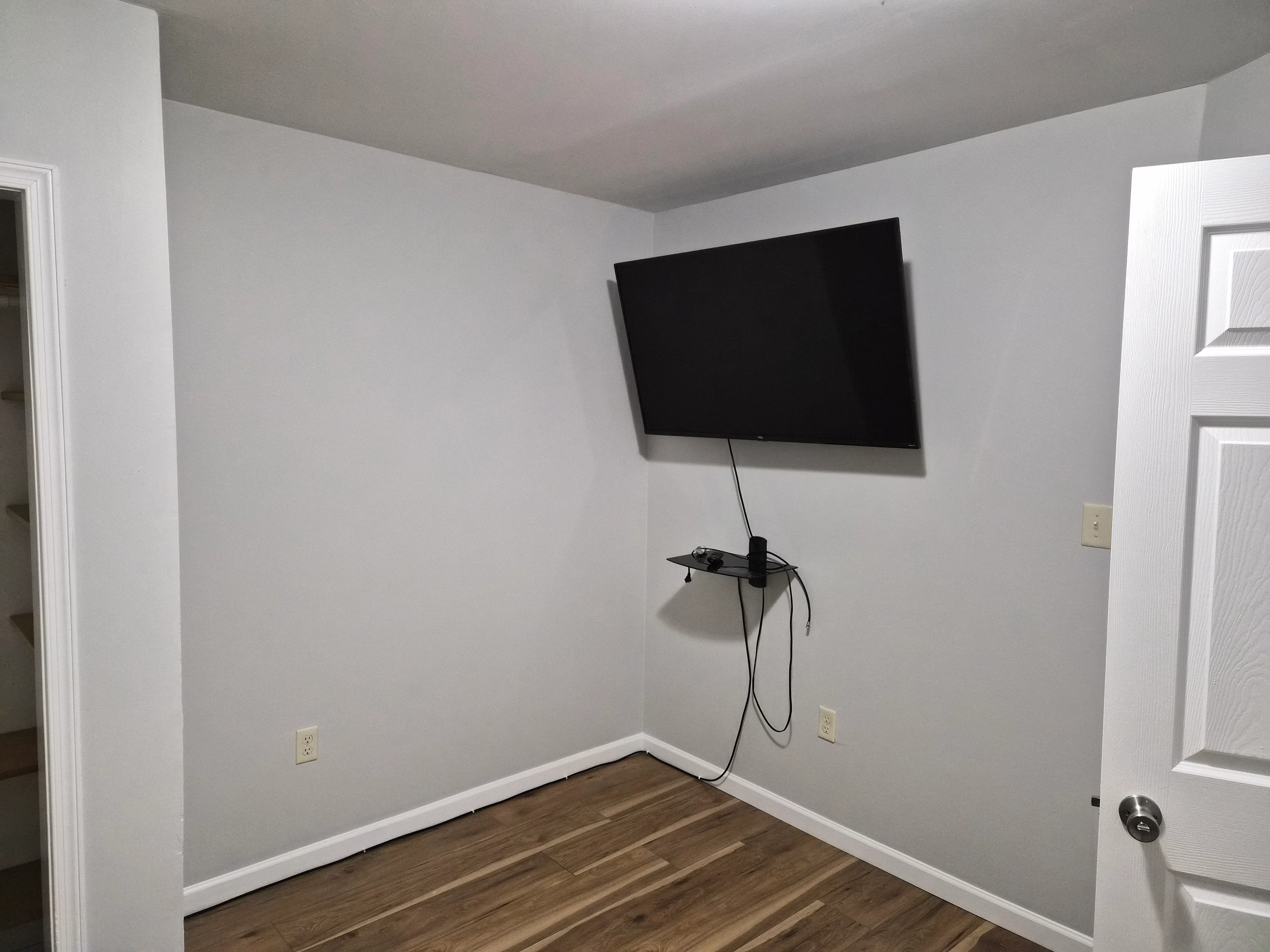 White painted walls and ceiling with white trim, baseboard, and installed electrical outlets in finished room