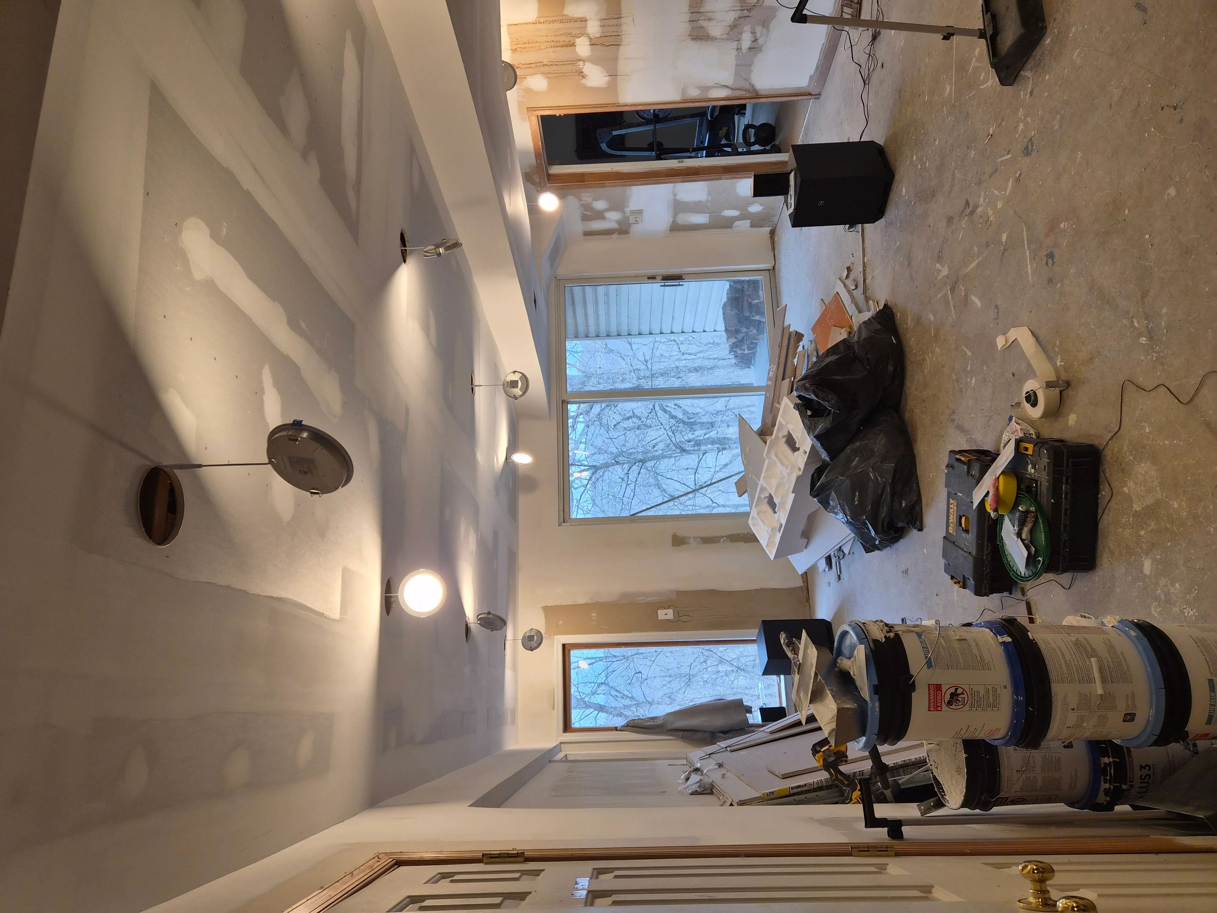 Drywall finishing work with recessed lighting and painted walls in residential interior