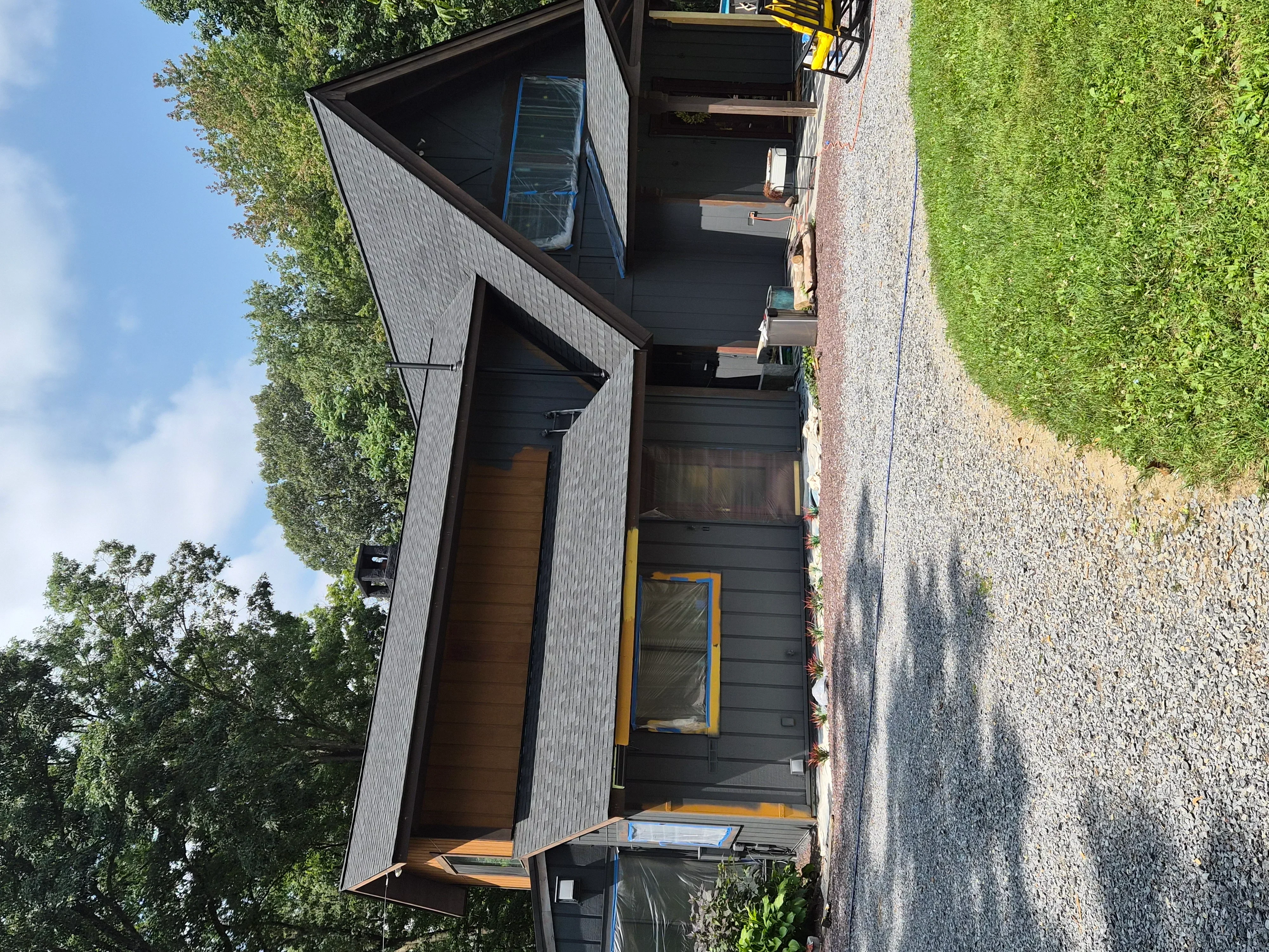 Dark gray painted fiber cement siding with contrasting trim on modern residential exterior