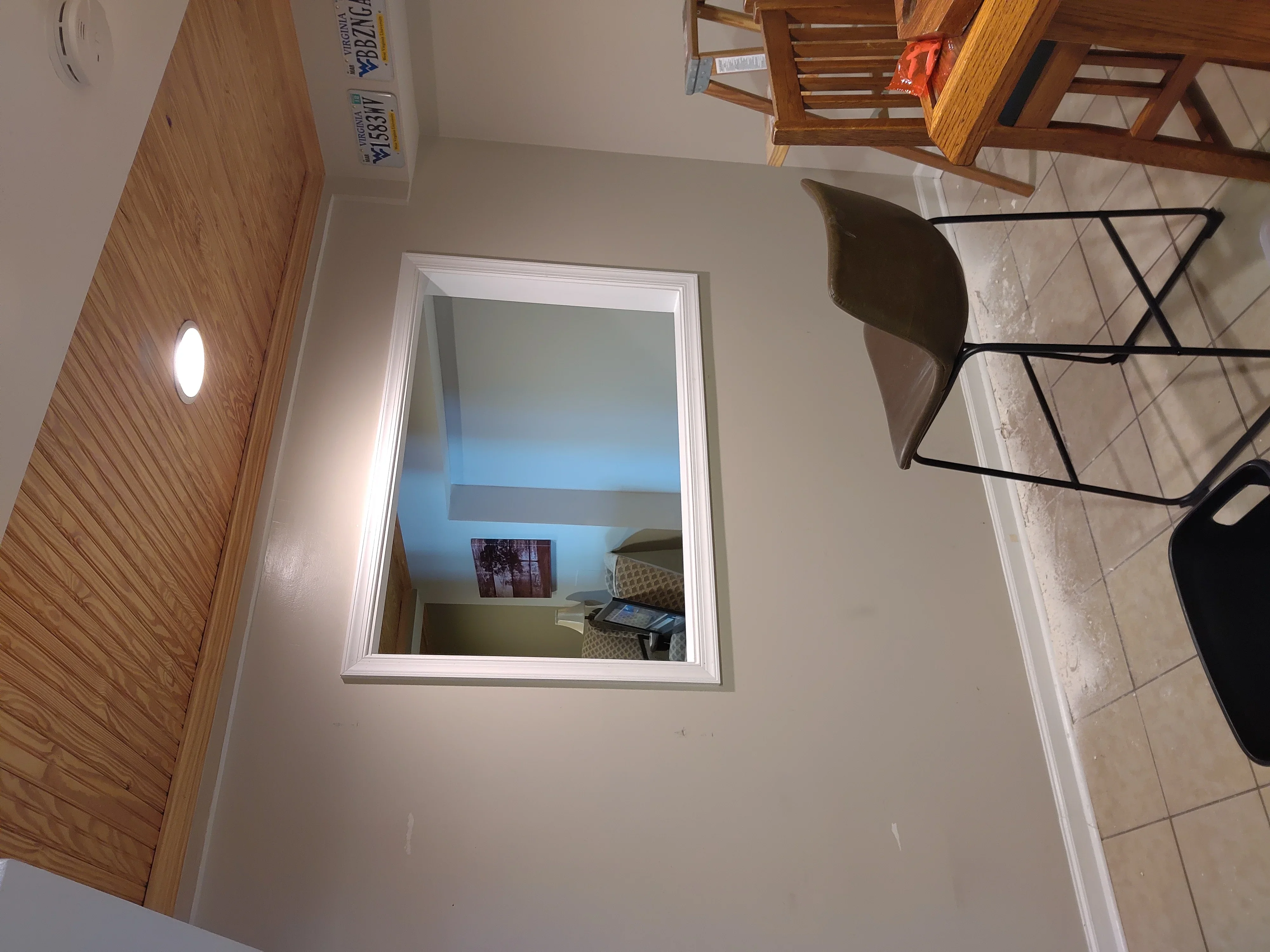 Bedroom interior with blue accent wall, beige paint, white trim, and recessed lighting