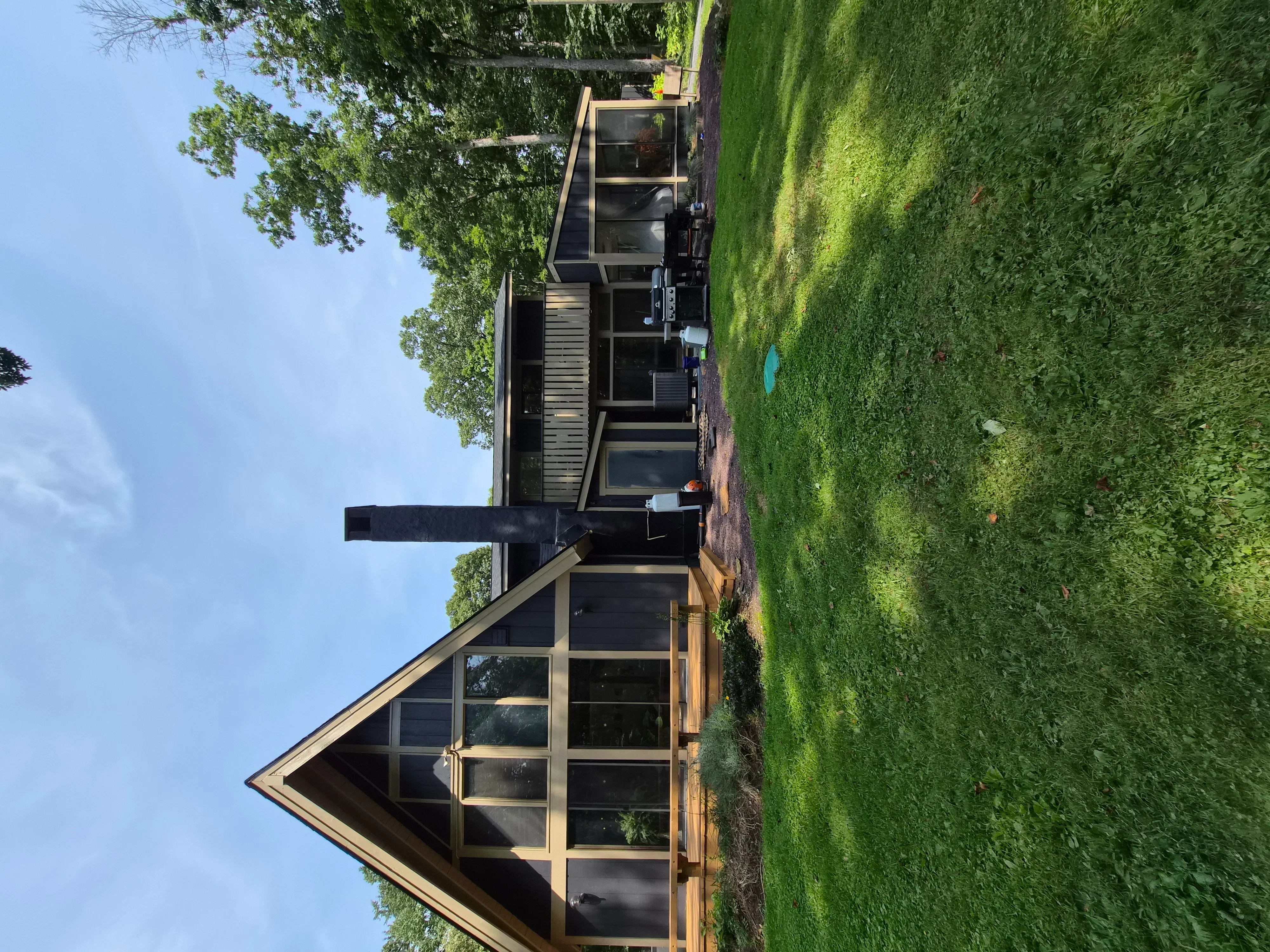Black painted siding with natural wood trim and window frames on modern home exterior