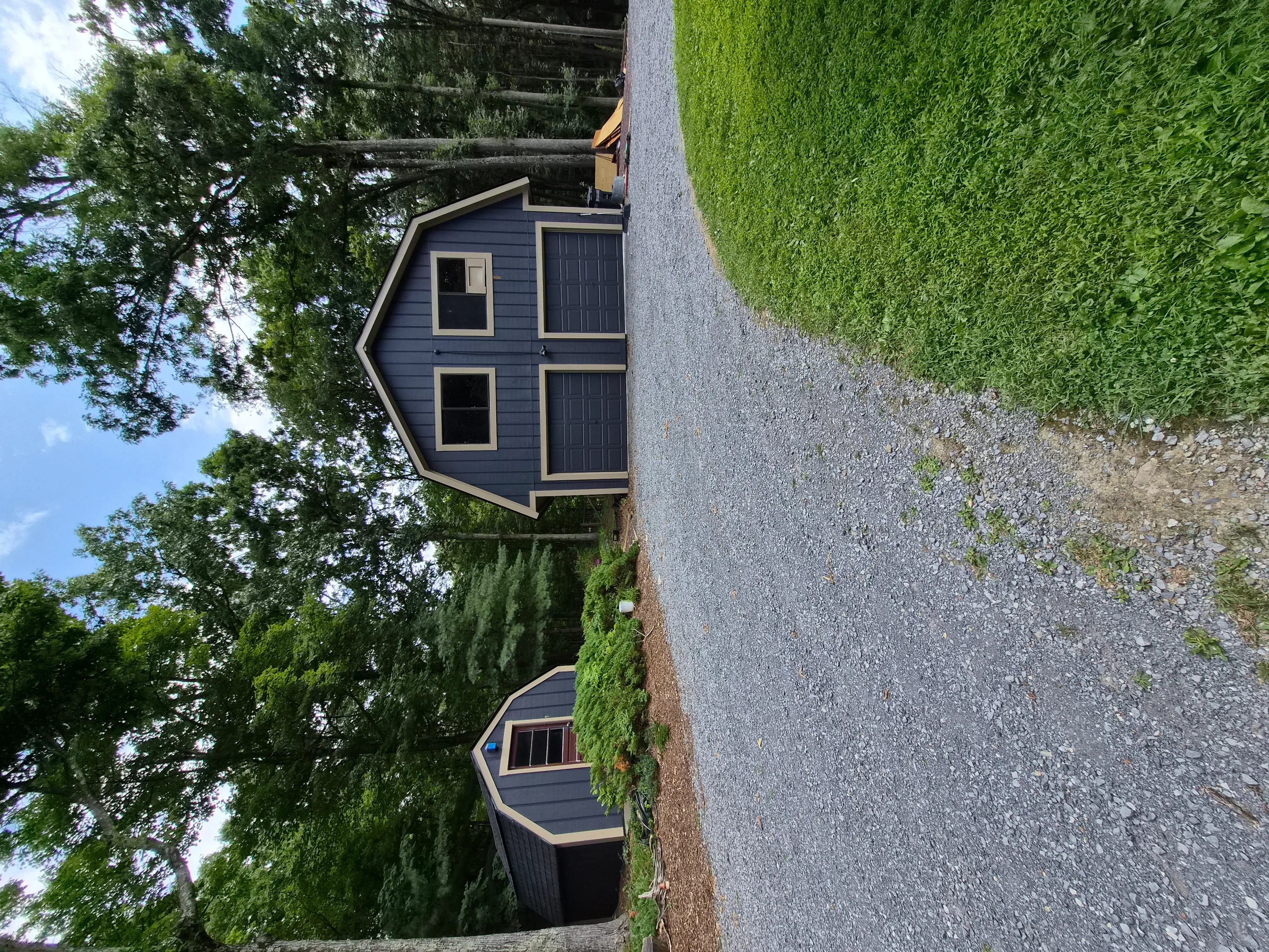 Dark blue painted house exterior with white trim, windows, and doors on residential home