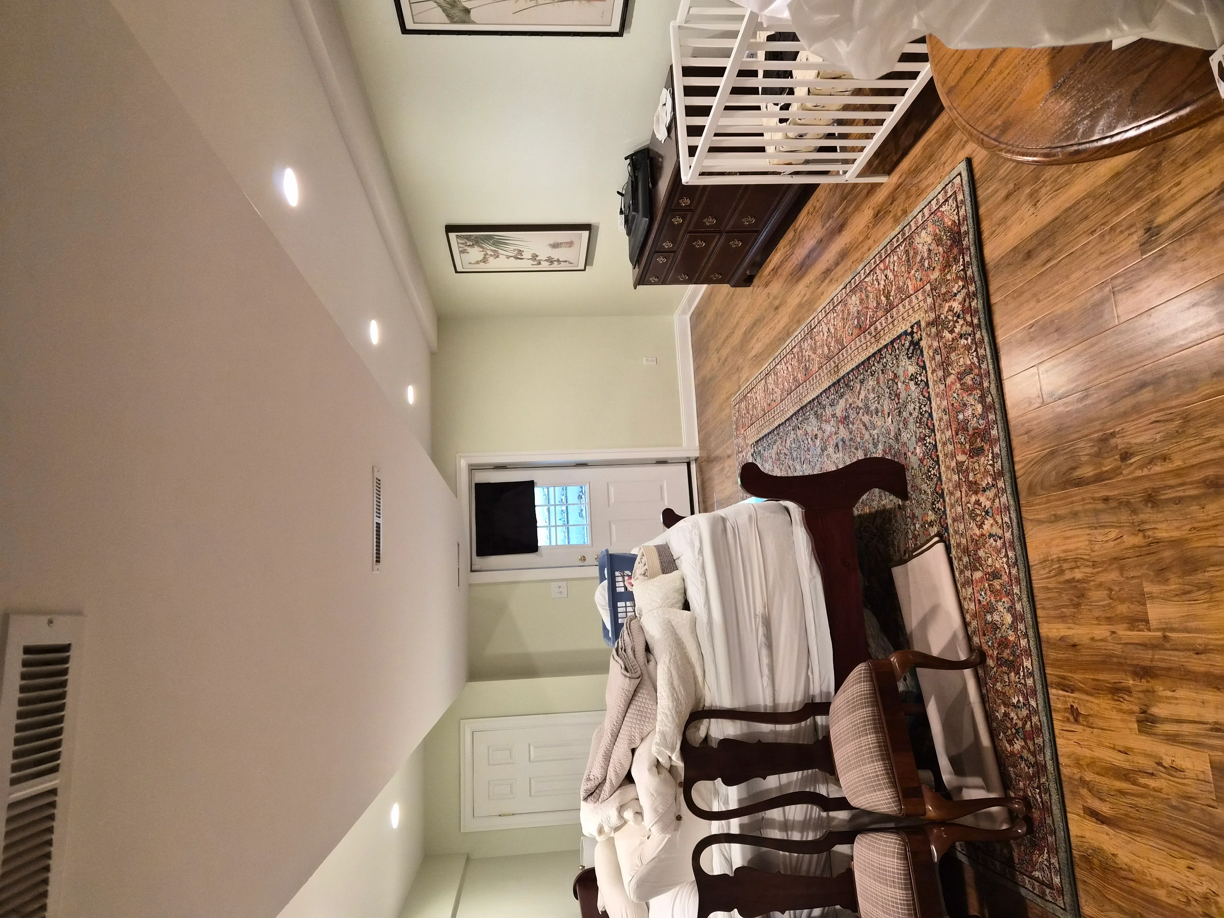 Painted bedroom interior with neutral walls, recessed lighting, and finished trim work