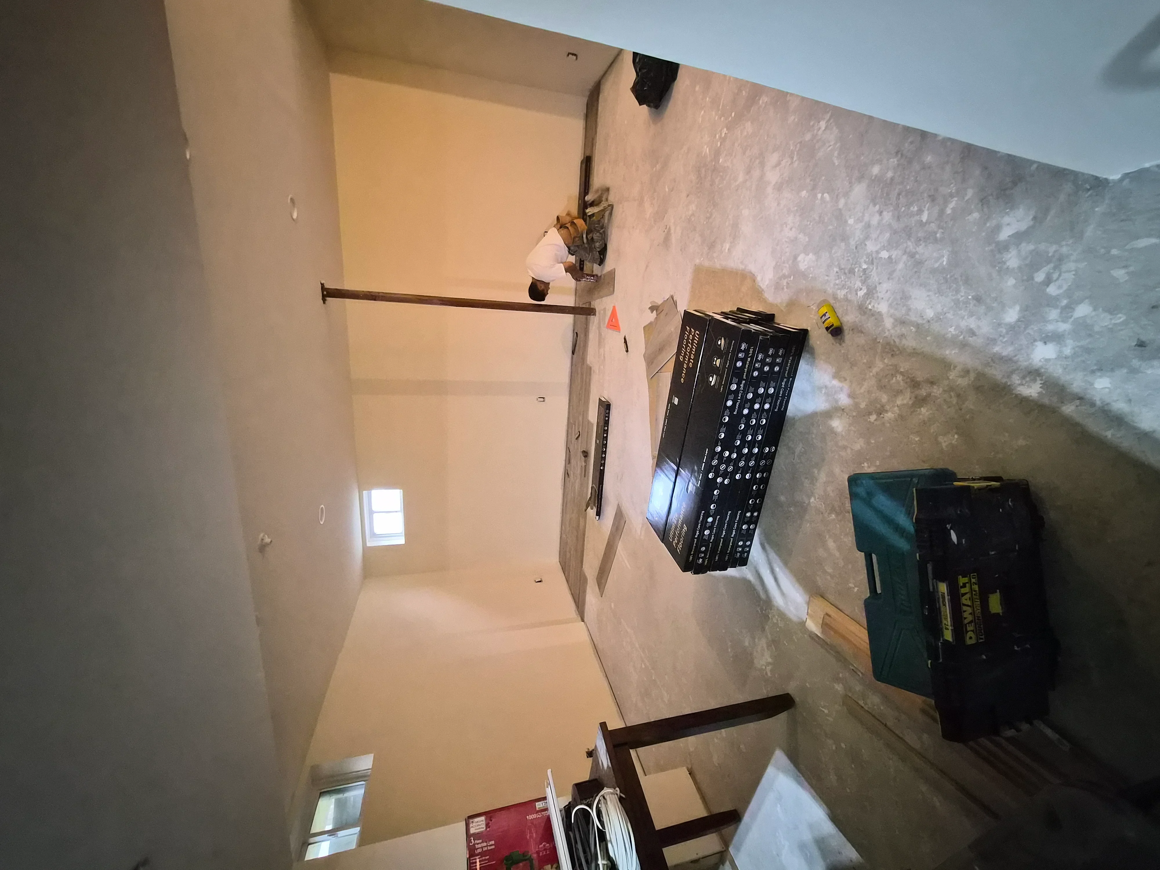 Interior room with primed drywall, joint compound, and prepared walls ready for painting