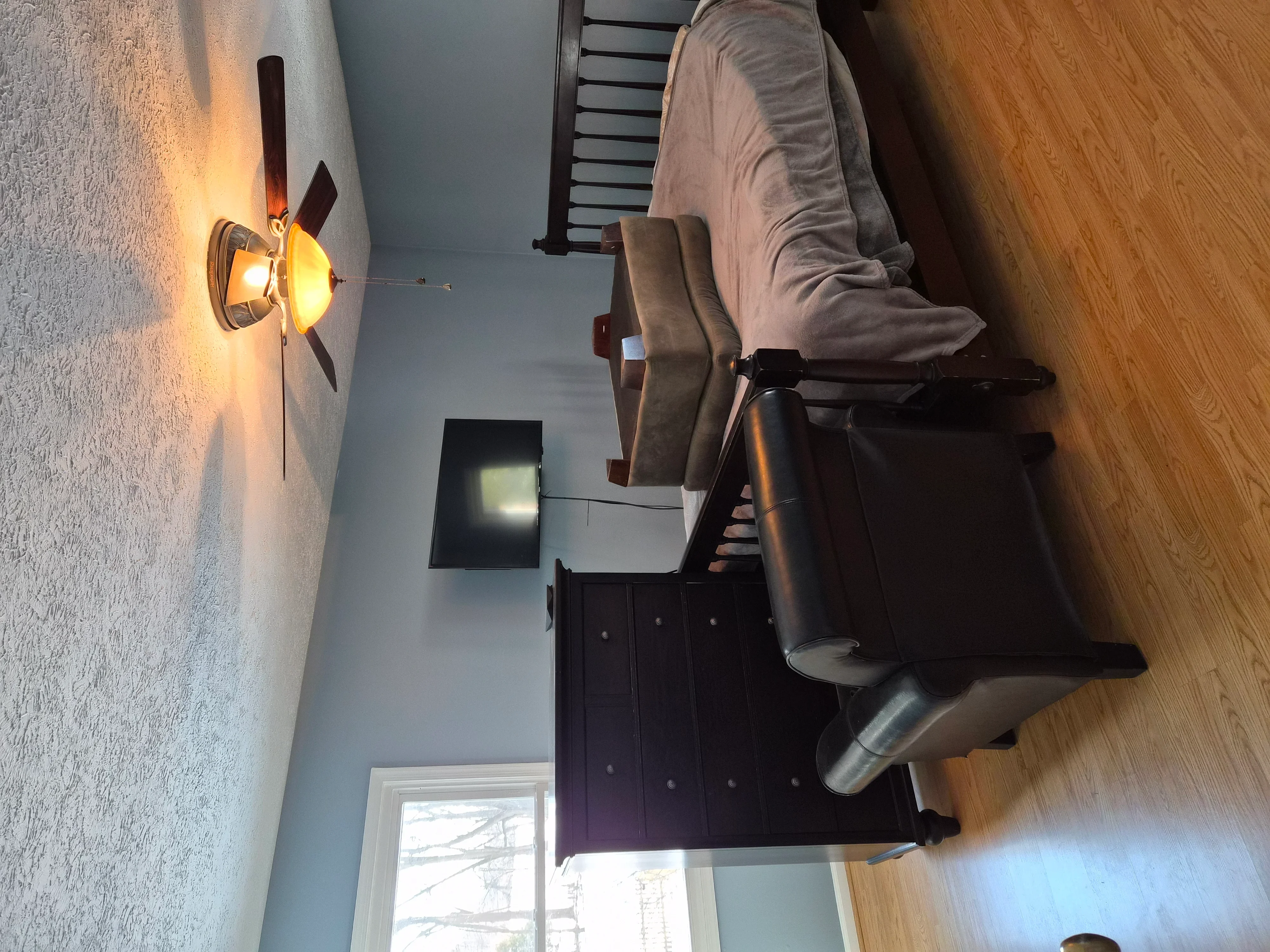 Interior room with textured gray walls, white ceiling, and hardwood floors after professional painting