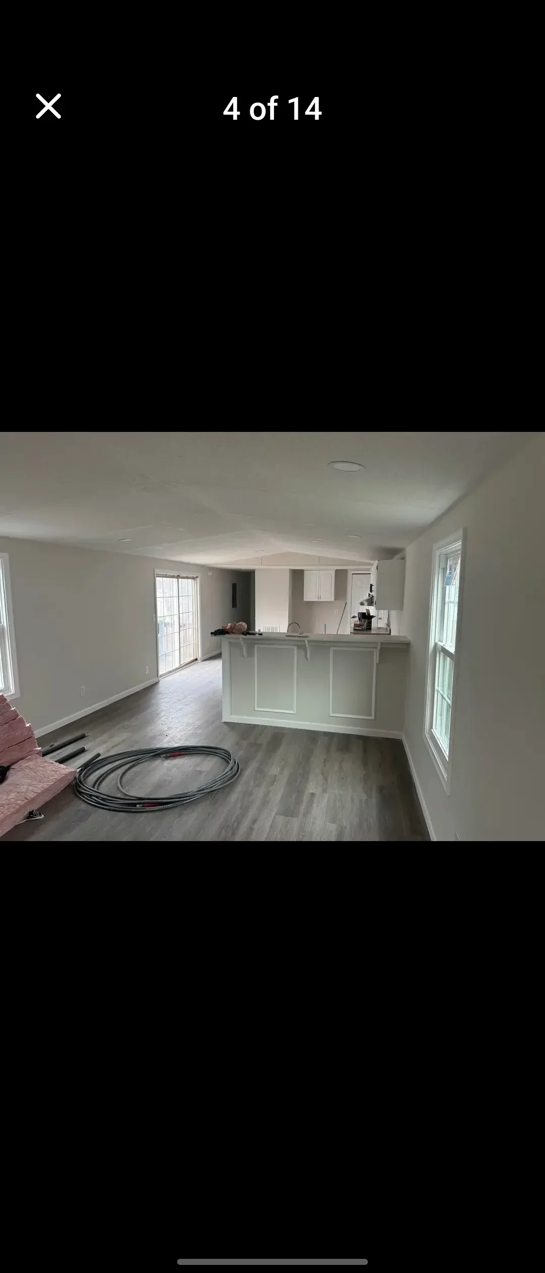 Freshly painted interior walls and ceiling in white, open-concept living space with kitchen island